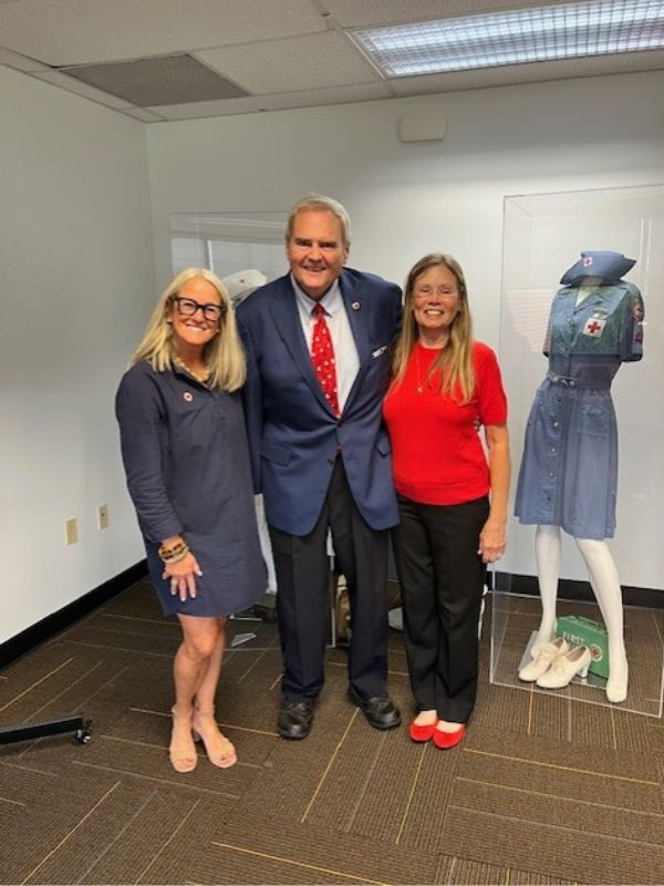 volunteer standing with partner and red crosser