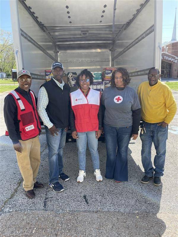 Group of volunteers standing in front of a truck