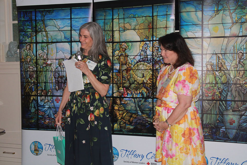 Joanne Sowell and Tracy Wade speak using a microphone at the 2025 Tiffany Circle Spring Gathering.