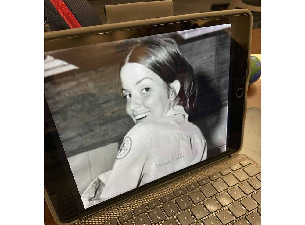 Old photo on a laptop computer of Dorner Carmichael in her Donut Dolly uniform in Vietnam.