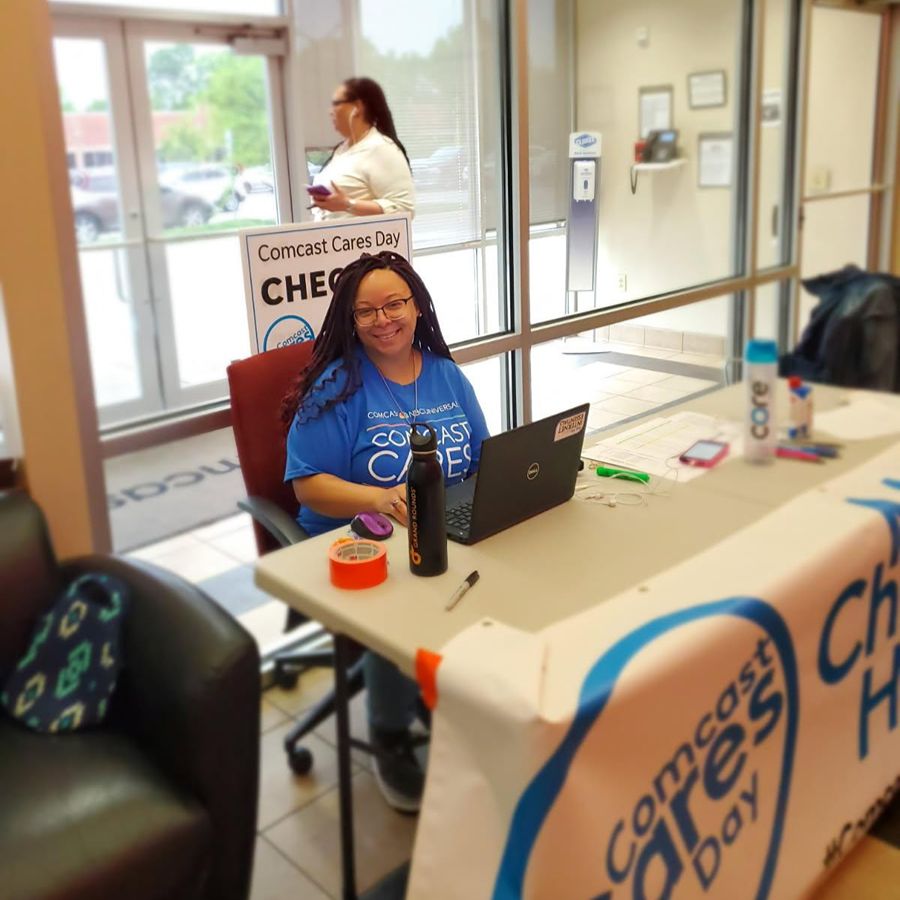 Toya volunteering, sitting at a desk