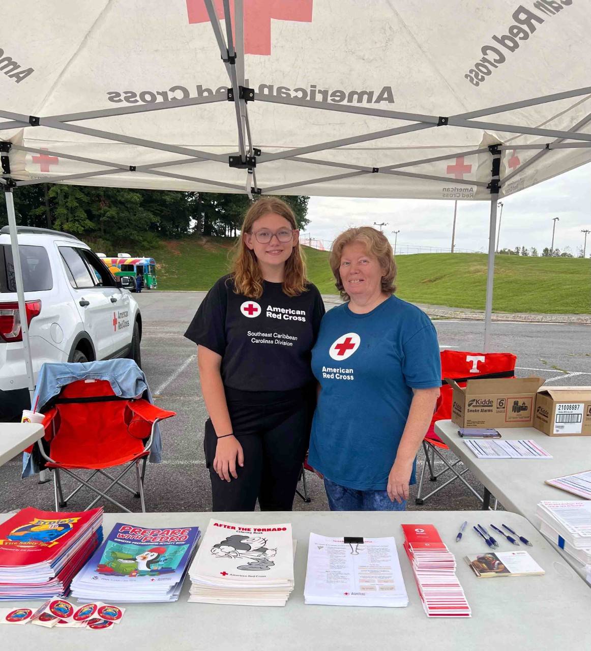 Melissa Gibson works a fire safety booth with another Volunteer