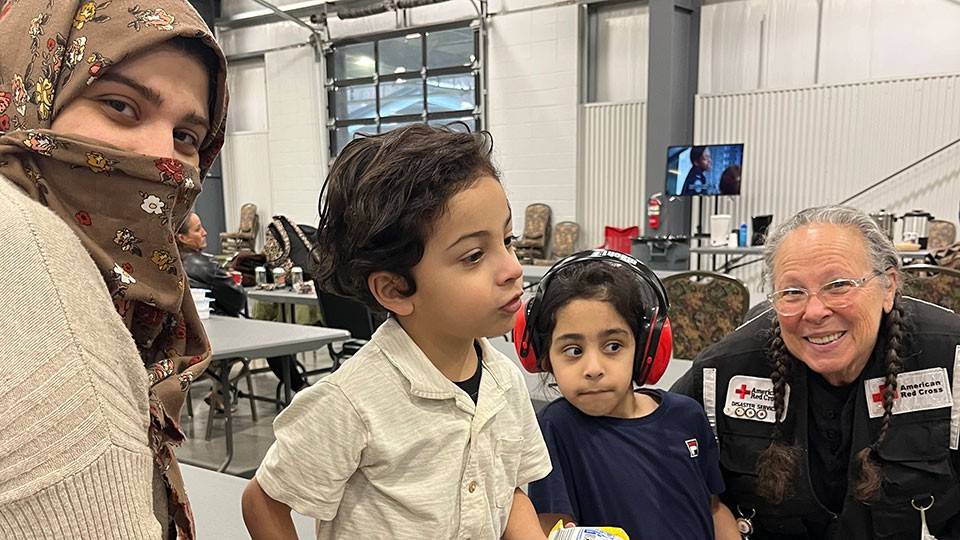 Ola and her sons and volunteer Eileen Wallach at Nashville Fairgrounds shelter.