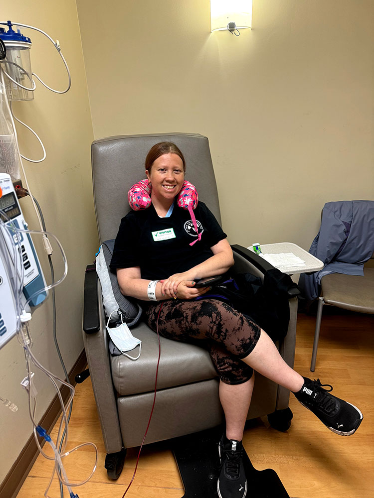 Savannah Speer sitting in chair with neck rest and donating blood.