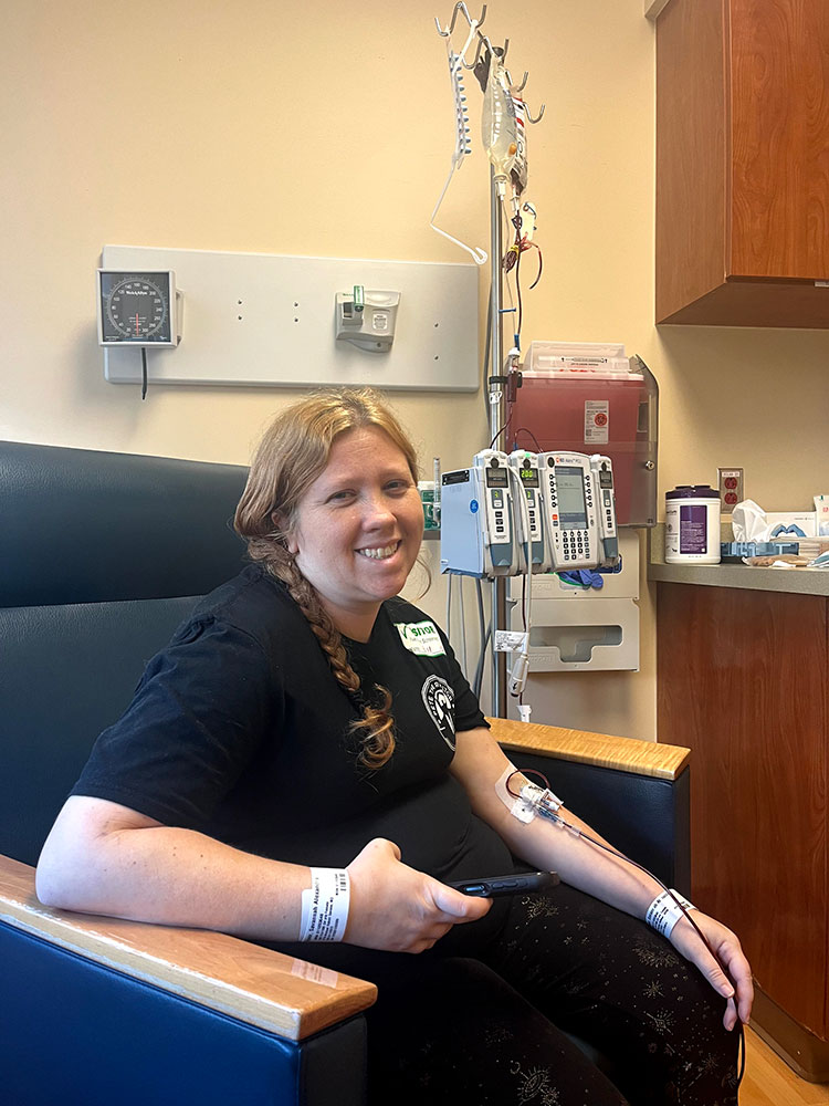 Savannah Speer sitting in chair and donating blood.