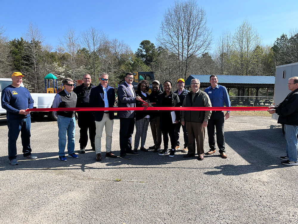 Group of people at ribbon cutting ceremony.