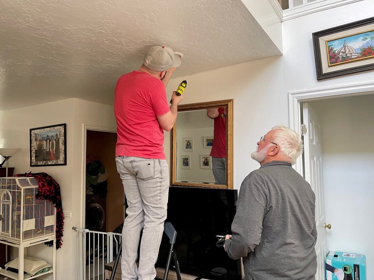 red cross volunteer installing a smoke alarm in a home