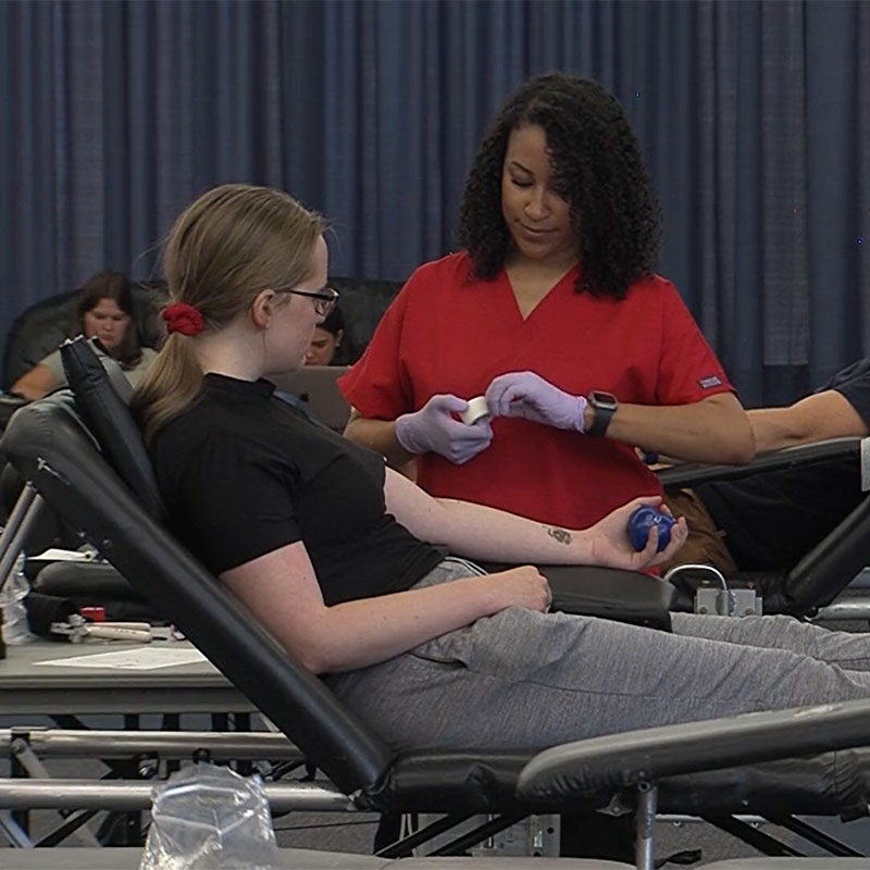 Red Cross nurse getting ready to take blood