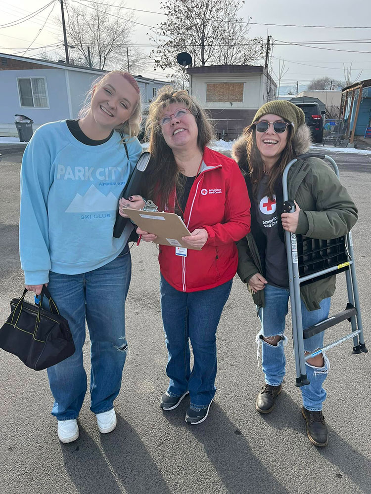 Three Red Cross volunteers ready to help residents.
