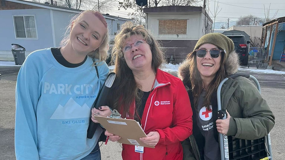 Three Red Cross volunteers ready to help residents.
