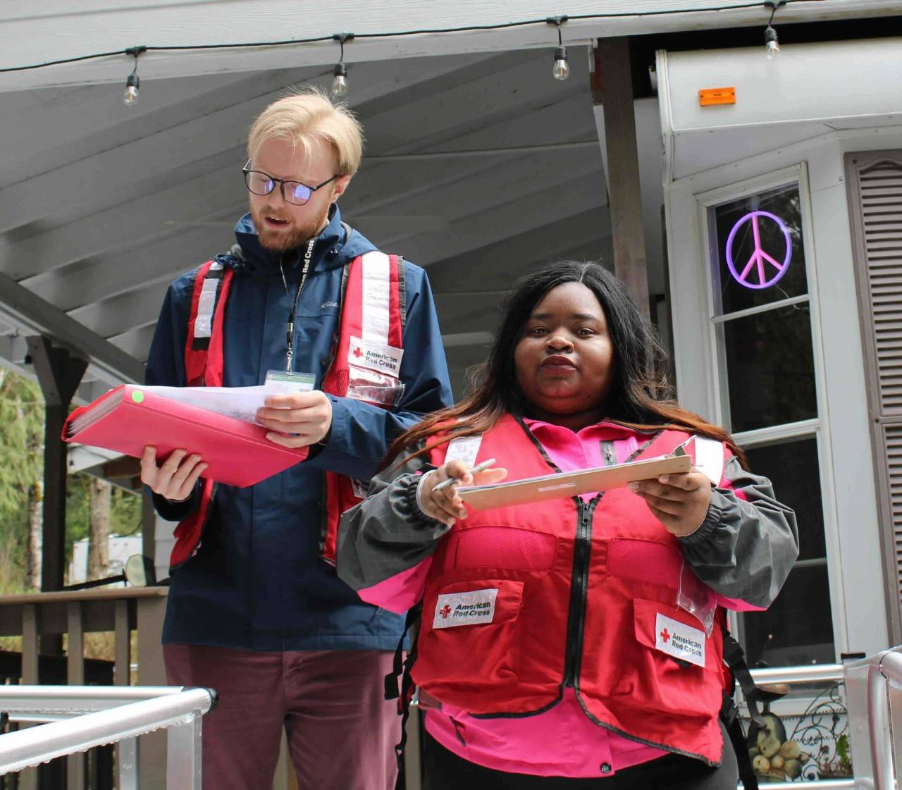 Hope Marozwa and other Volunteer on porch