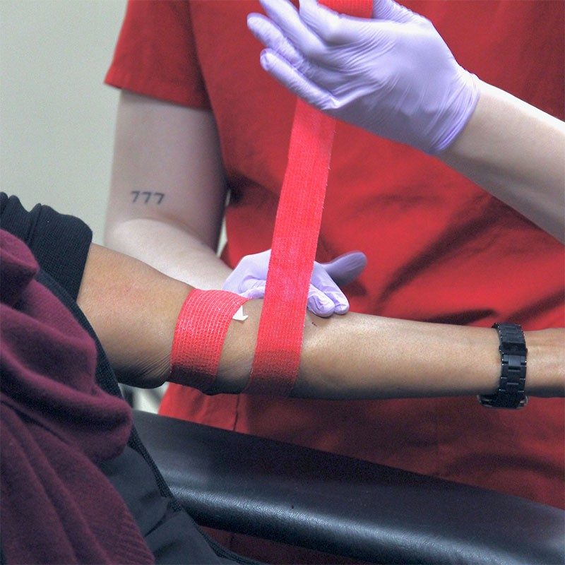 Arm being wrapped for blood donation