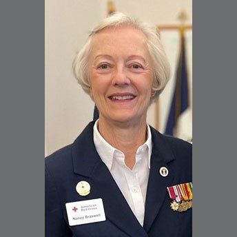 Nancy Braswell in military jacket with medals.