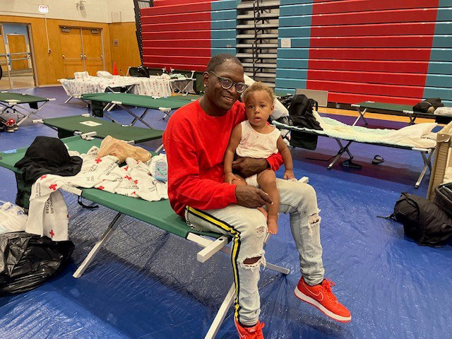 Ricardo Pruett and his one-year-old son Martrix in a Red Cross shelter.