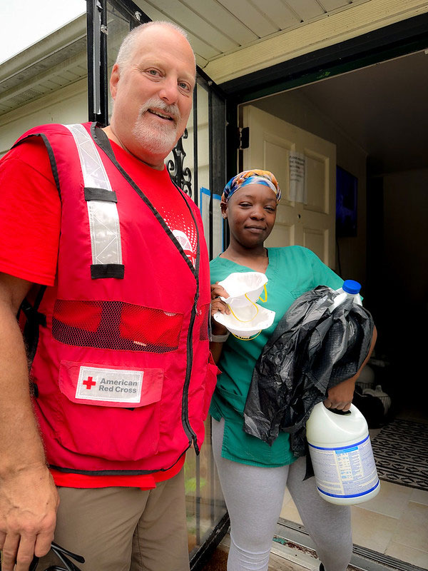 Red Cross volunteer helping resident Maureen Herzog.