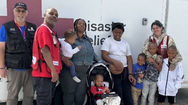 Red Cross volunteers and the Thompson family group photo.