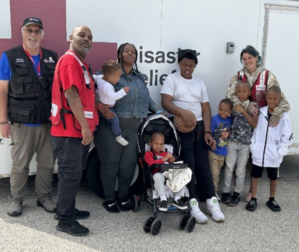 Red Cross volunteers and the Thompson family group photo.