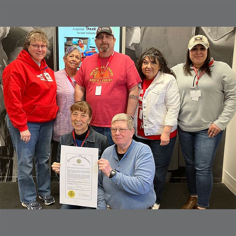 Group photo of Red Cross volunteers at Safe Kids Day event.