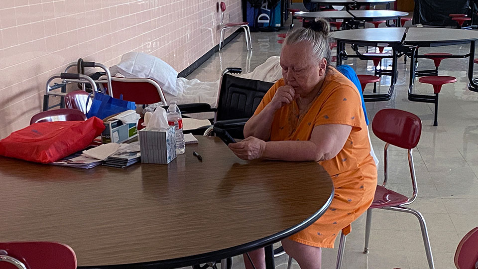Kimberly Jewell sitting at table looking phone