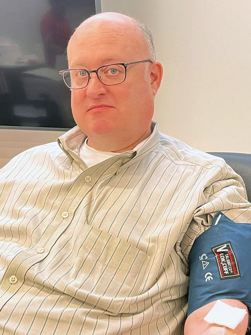 Man sitting in chair giving blood