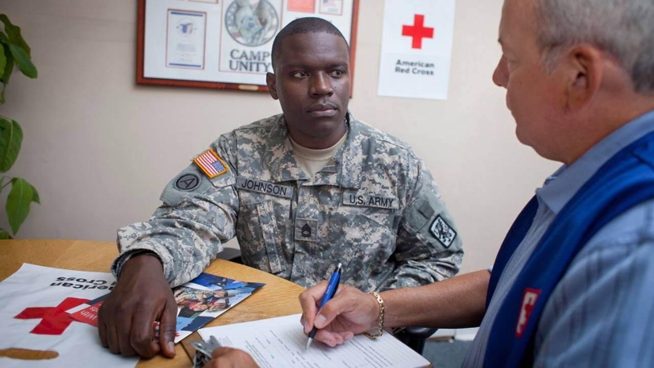 u.s. service member speaking with red crosser