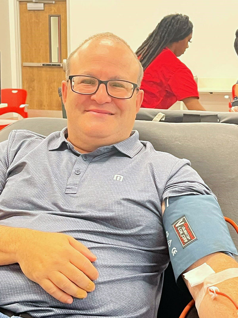 Man sitting in chair giving blood