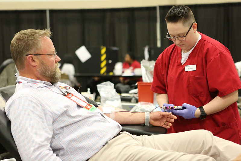 Man sitting in chair donating blood