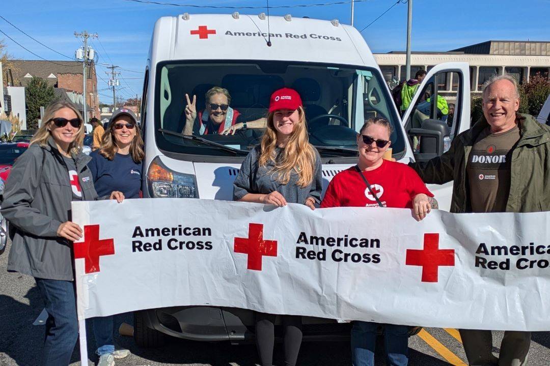 Group of Red Cross volunteers march in parade