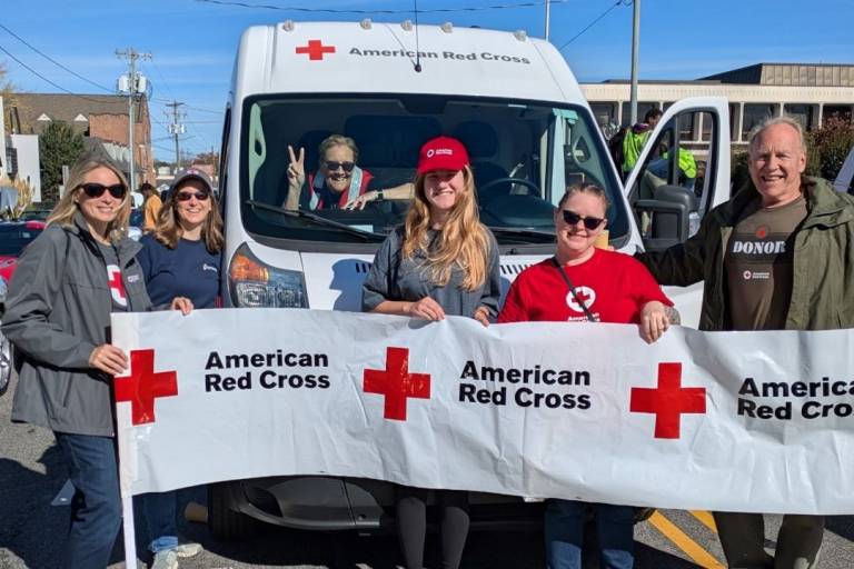Group of red cross volunteers march in parade