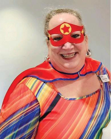 Susan Steed wearing a custom super hero outfit with a mask over her eyes.