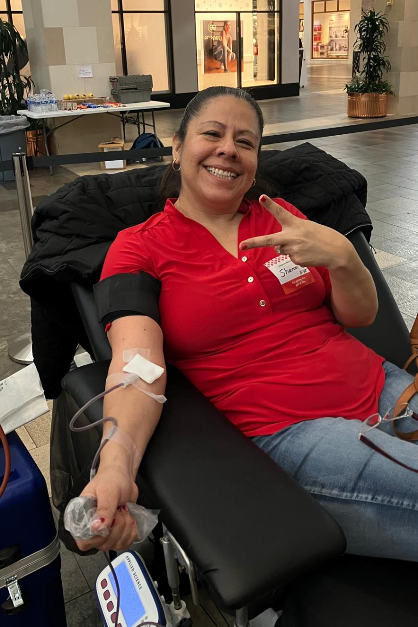 Woman smiles while donating blood