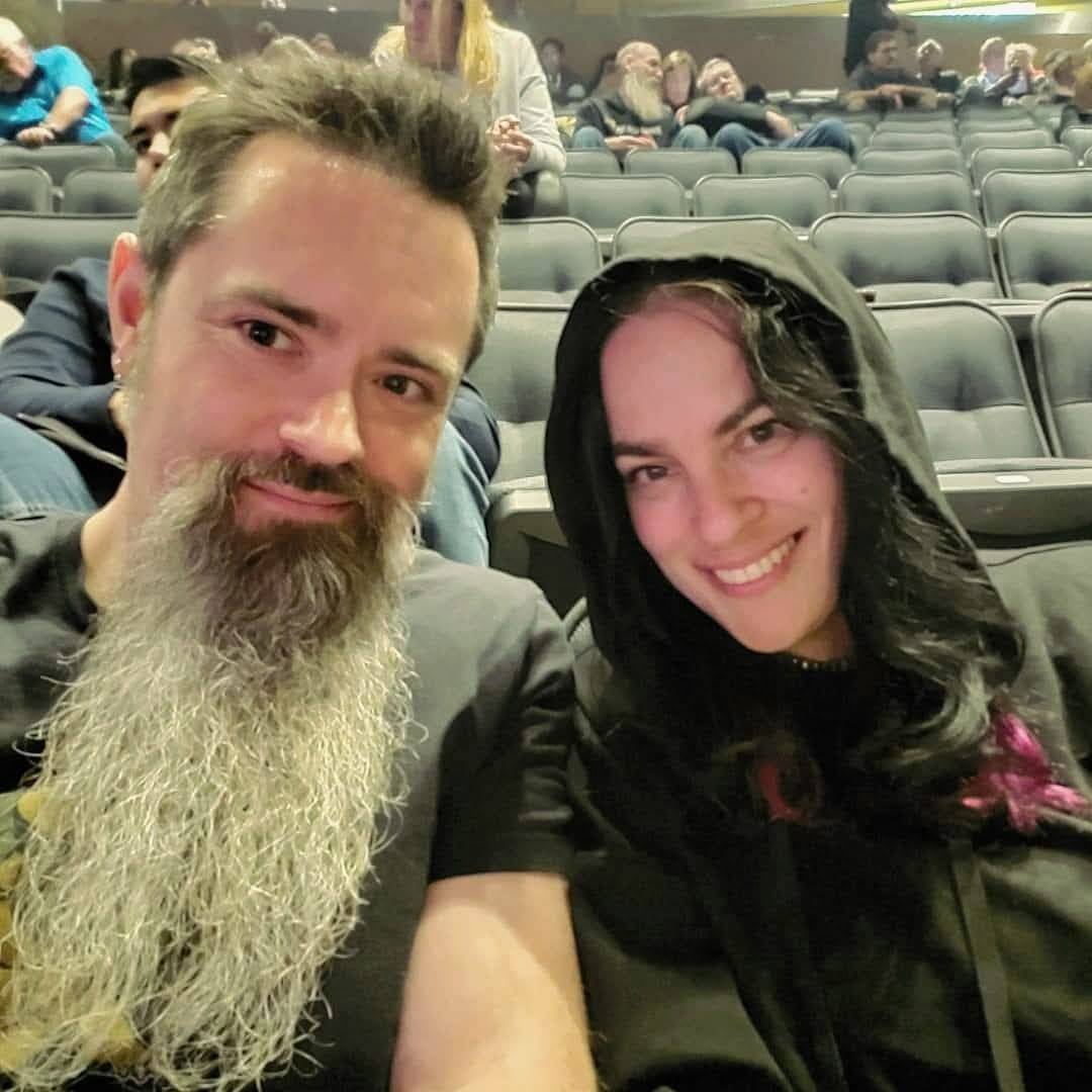Man and woman sit in stadium seating