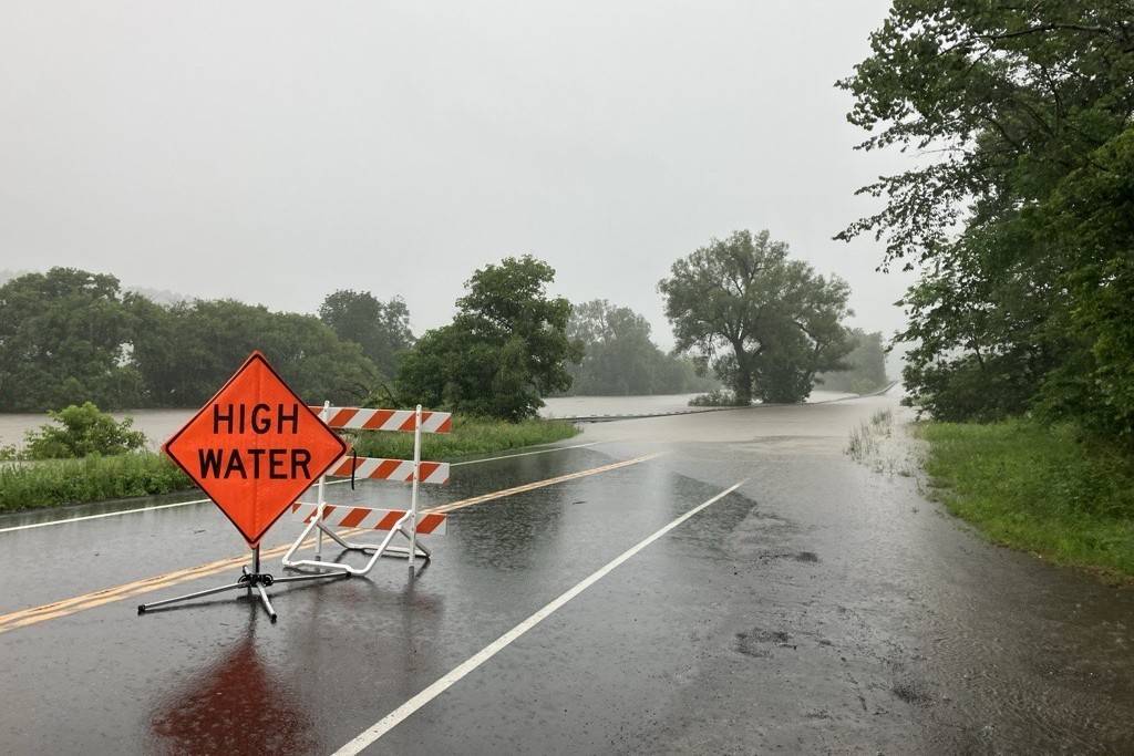 Flooded road with High Water sign