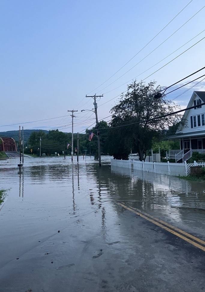 Flooded road in front of homes