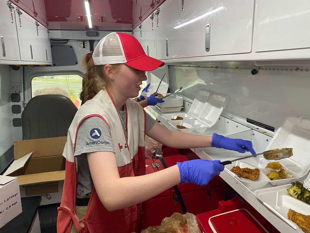 Red Cross volunteer serving food