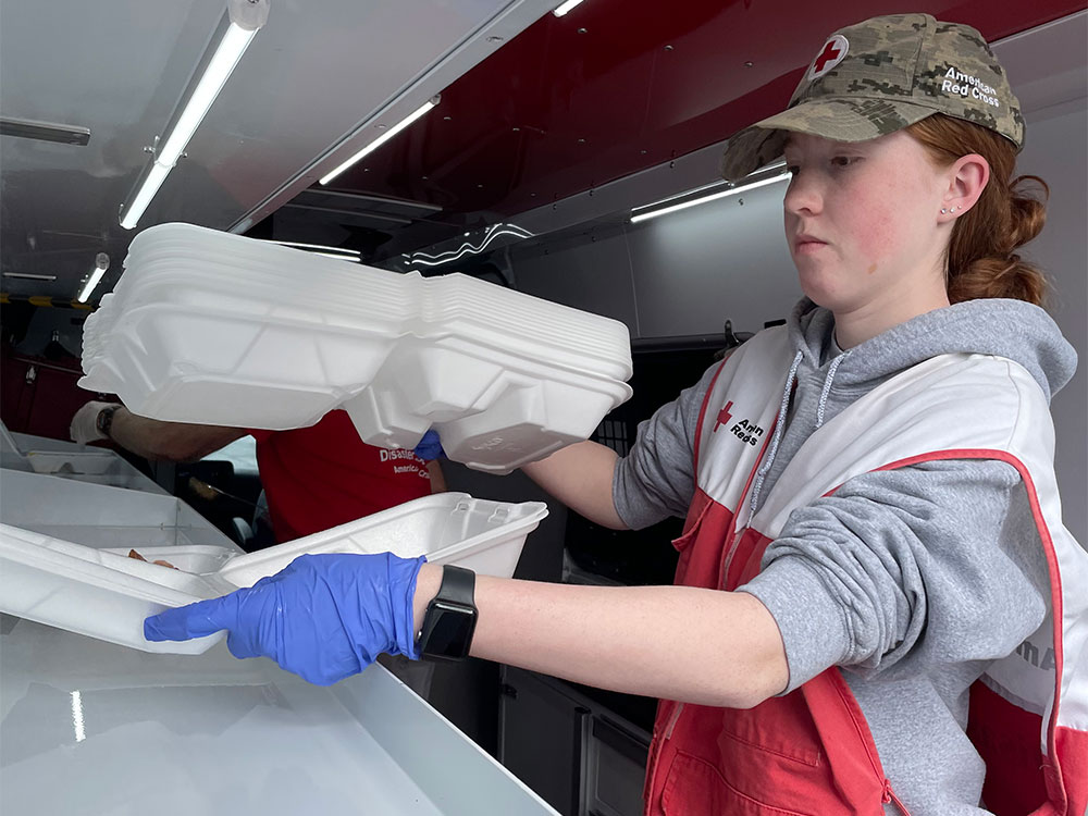 Red Cross volunteer serving food