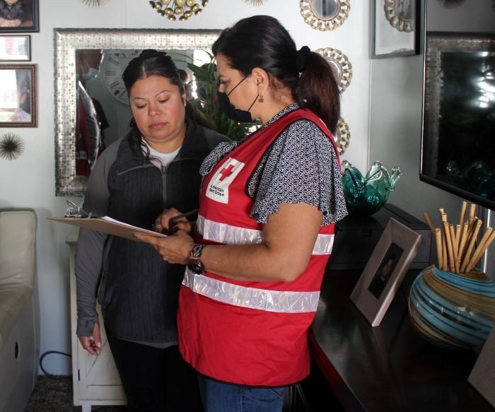 Red Cross volunteer interacts with client during home fire safety visit