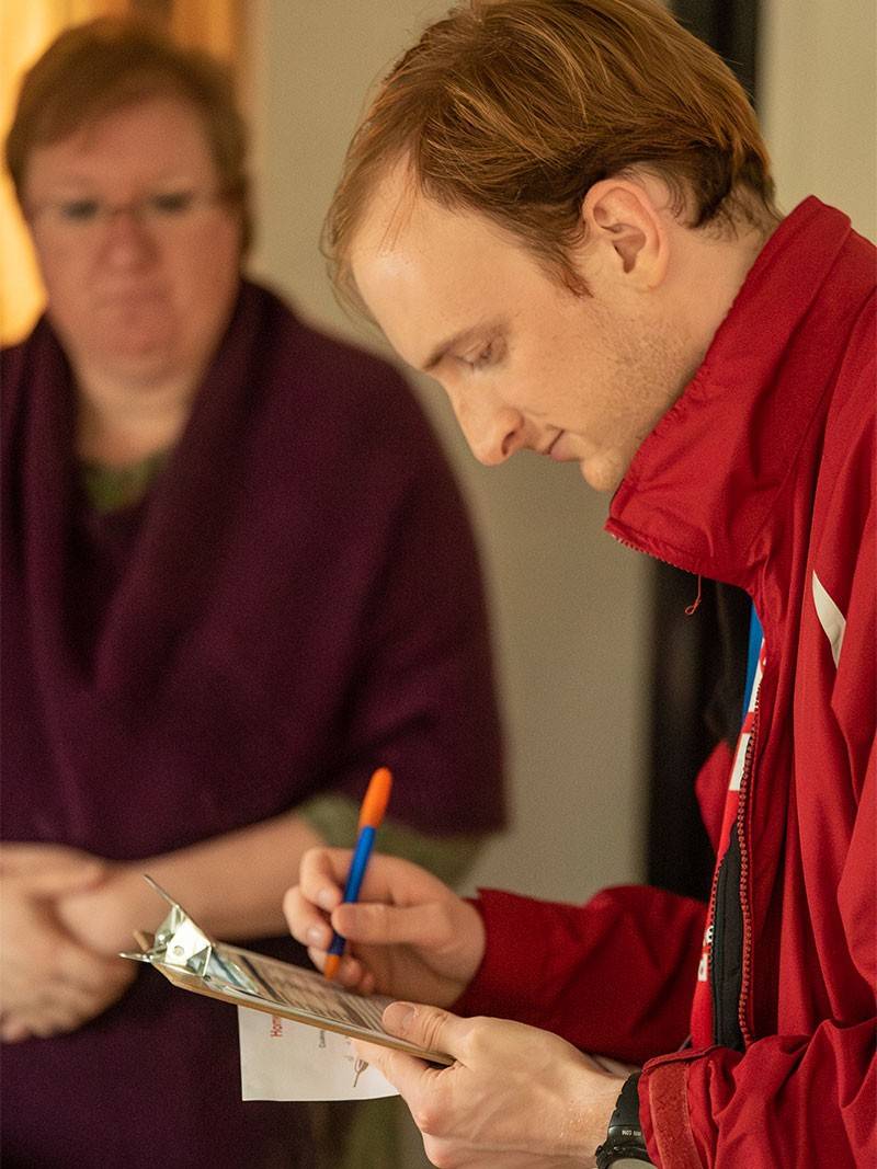 Red Cross volunteer taking notes