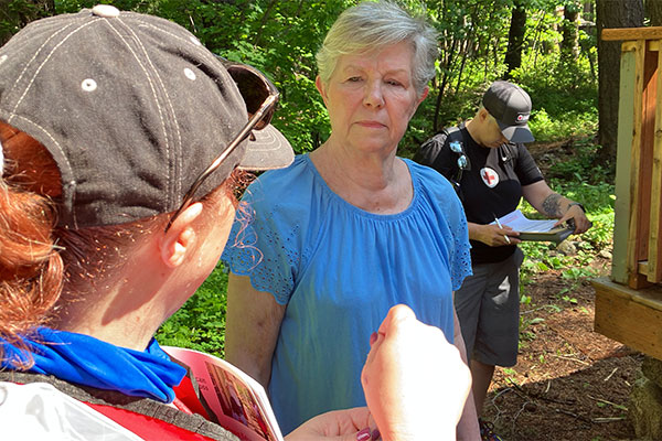 Red Cross volunteer talking with resident