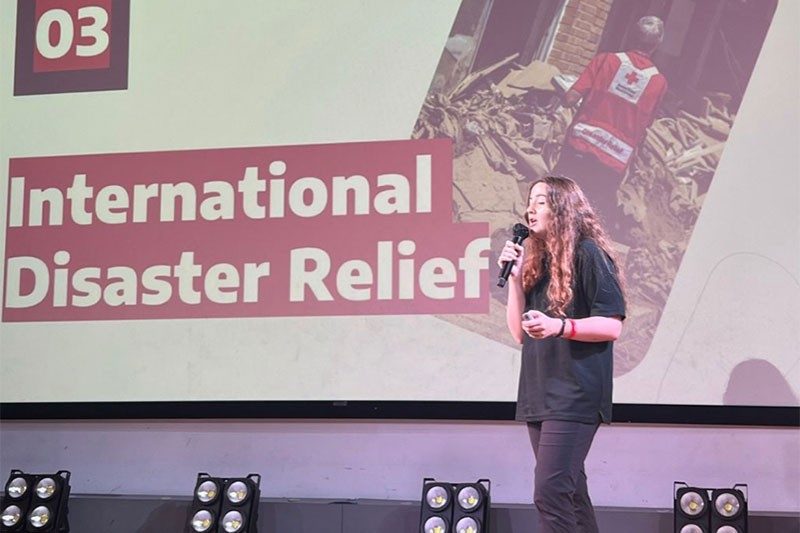 Cara Elzie on stage speaking with mic