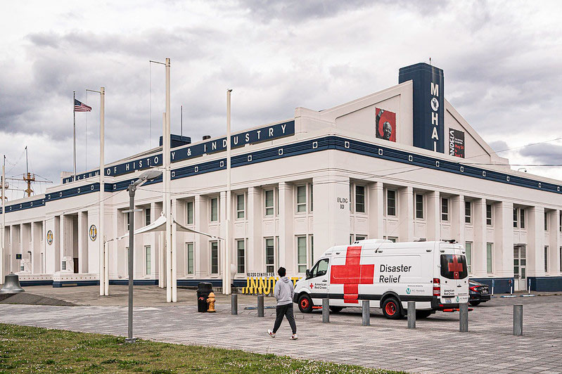 red cross vehicle outside of the museum history and industry building.