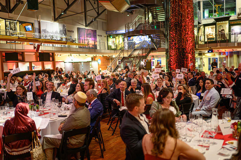 The 27th Annual Red Cross Hero Awards inside the museum history and industry building with people sitting at their dinner tables.
