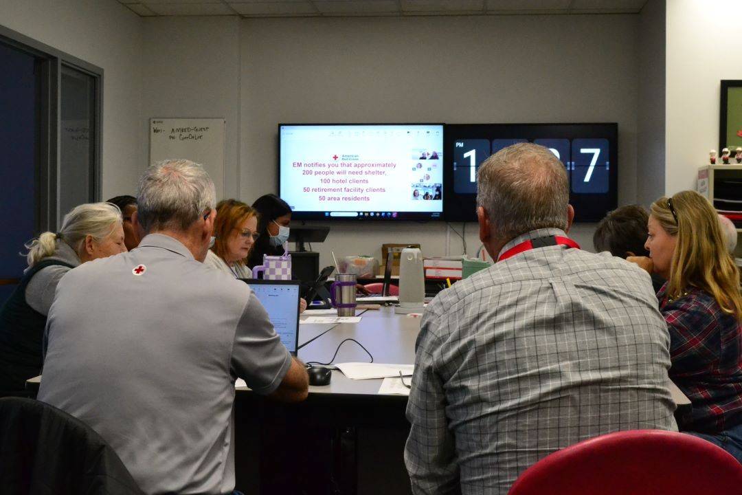 Group of people sit and work around tables