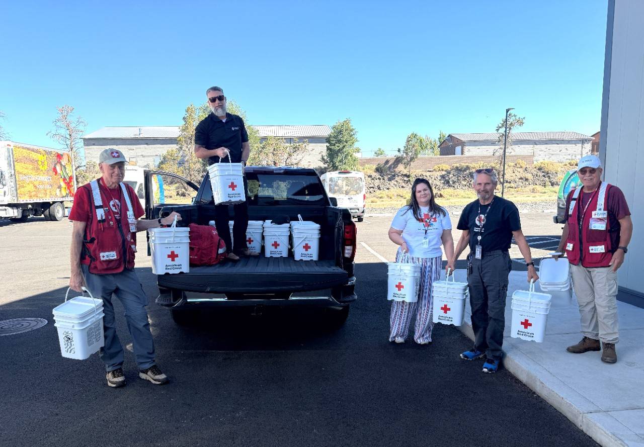 Group of Red Cross volunteers deliver clean-up kits