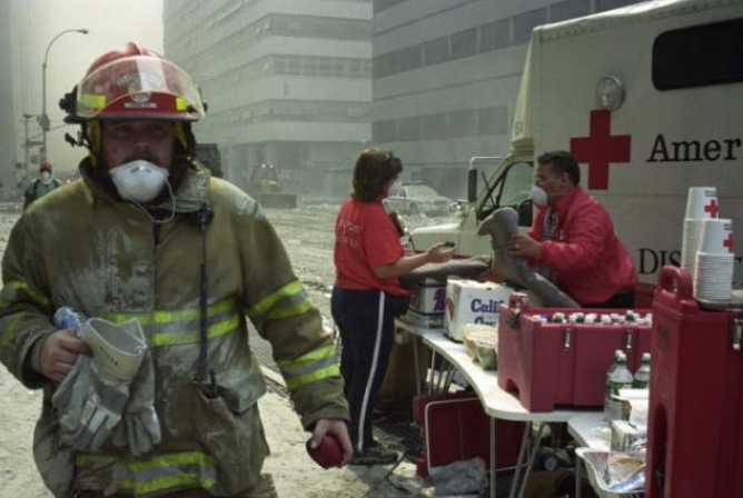 Firefighter and Red Cross workers pictured among destruction after 9/11 attacks
