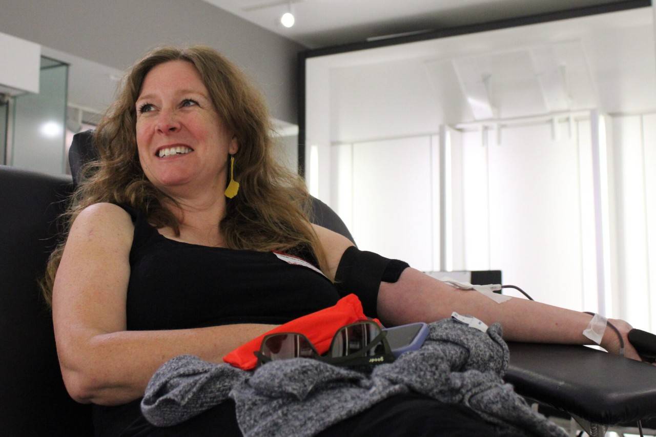 Woman smiles while donating blood