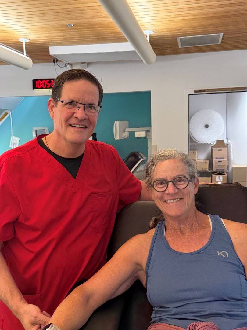 Paul stands next to female blood donor
