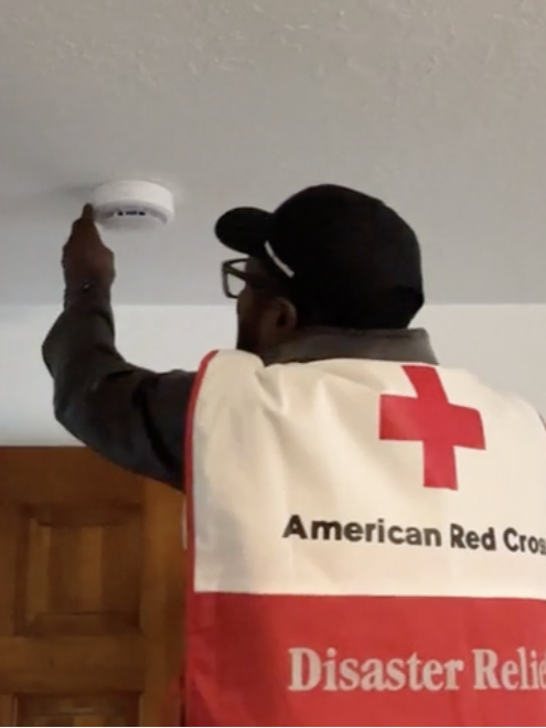 Red Cross volunteer checking smoke alarm