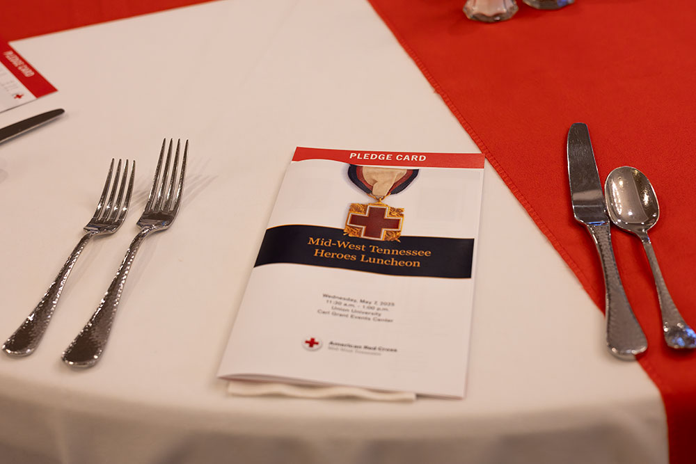 Mid-West Tennessee Heroes Luncheon pamphlet on dinner table.