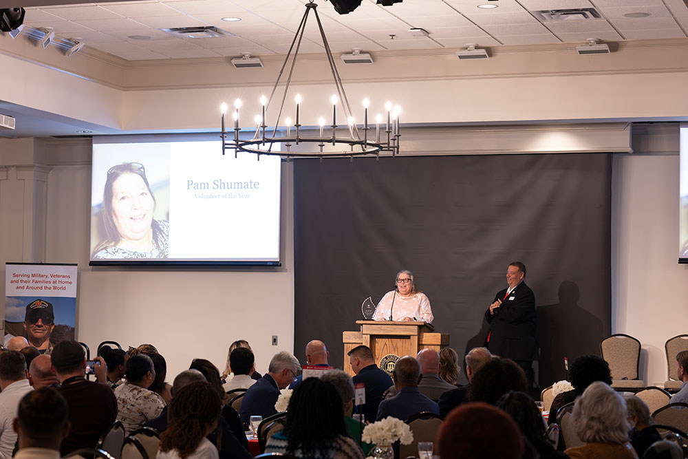 Pam Shumate Volunteer of the Year speaking at podium at the Mid-West Tennessee Heroes Luncheon..